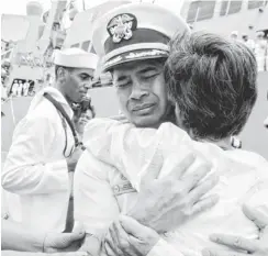  ?? HENG SINITH, AP ?? U. S. naval officer Michael Vannak Khem Misiewicz embraces his aunt in 2010. He has been arrested in connection with a Navy bribery scandal that has embroiled some top- ranking officers.