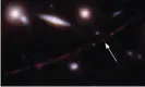  ?? Photograph: Space Telescope Science Institute /AP ?? The star Earendel, the most distant ever identified, indicated by an arrow, and the Sunrise Arc galaxy revealed by Hubble.