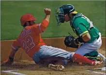  ?? BEN MARGOT — THE ASSOCIATED PRESS ?? The Angels’ David Fletcher, left, scores past A’s catcher Austin Allen in the first inning Saturday. The A’s lost at home for the first time since July 29.