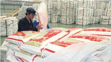  ??  ?? Workers arrange rice for export at a processing plant in Ayutthaya province. The Foreign Trade Department says Thai rice prices are competitiv­e in the world market.