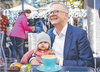  ?? Picture: Sam Ruttyn ?? Anthony Albanese was happy to be Melbourne on Tuesday. left holding the baby while campaignin­g in