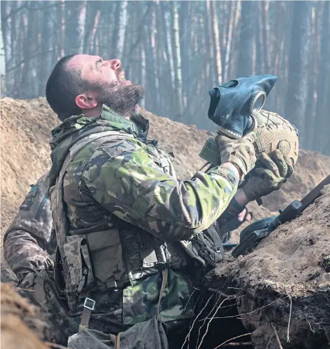  ?? ?? Soldiers fighting on the front line are required to carry gas masks with them at all times. Some units report coming under gas attacks ‘almost daily’