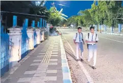  ?? AFP ?? High school students in Kupang walk to school early in the morning on March 6.