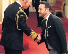  ??  ?? RECOGNITIO­N: Ant receives his OBE from the Prince of Wales last year