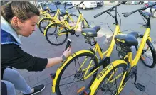  ?? HUANG JIEXIAN / FOR CHINA DAILY ?? A rider in Qingdao, Shandong province, scans bar code for riding an ofo bike.