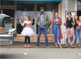  ?? Lea Suzuki / The Chronicle 2018 ?? Onlookers check out the 2018 Fourth of July parade in Sausalito. As the U.S. continues to grapple with the pandemic, this year’s celebratio­ns won’t look quite the same.