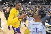  ??  ?? Durant gets a hug from his mother, Wanda, after winning Game 4 of the NBA Western Conference finals.