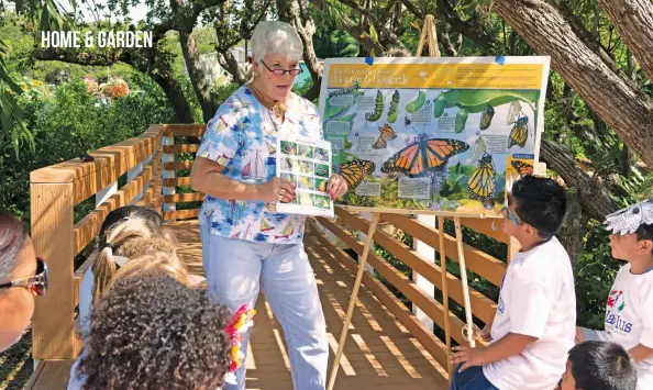  ??  ?? A group of students visiting Shell Point’s butterfly habitat learn about the winged creatures from Shell Point resident and volunteer Lynda Freisner.