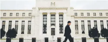  ??  ?? A man walks past the Federal Reserve Bank in Washington. — Reuters photo