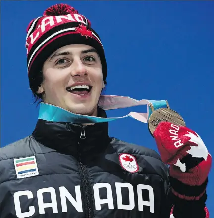  ?? JAVIER SORIANO/AFP/GETTY IMAGES ?? Bronze-medal winner Mark McMorris poses on the podium during the medal ceremony for the snowboard Men’s Slopestyle at the Pyeongchan­g 2018 Winter Olympic Games. McMorris showed the true Olympic spirit by coming back from a devastatin­g injury.