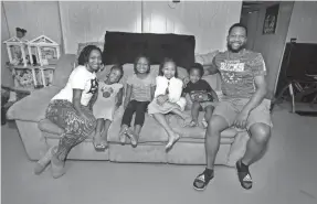  ?? RICK WOOD, MILWAUKEE JOURNAL SENTINEL ?? Robert and Jolie Brox are trying to keep their business afloat while their kids are schooling from home. The children are, from left: Nyemba, Ndaya, Mulaja and Ra’kem.