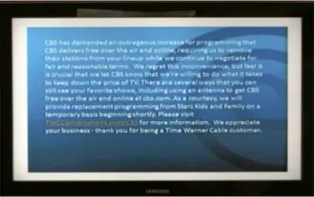  ??  ?? FILE - In this Friday, Aug. 2,2013, file photo, a television screen shows the CBS channel with an announceme­nt by Time Warner Cable in Los Angeles. Three million Time Warner Cable customers in New York, Los Angeles and Dallas are without the CBS...