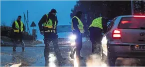  ?? — ap ?? Safety checks: Police officers checking documents at a checkpoint near the scene of a blast in Przewodow.