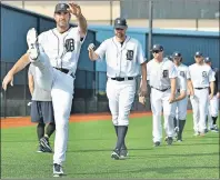  ?? ROBIN BUCKSON/DETROIT NEWS VIA AP ?? Detroit Tigers pitcher Justin Verlander, left foreground, warms up during a spring training workout in Lakeland, Fla., Tuesday.