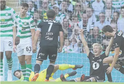  ??  ?? HANDS UP WHO SCORED Birger Meling, right, celebrates Rosenborg opener at Parkhead but riled-up Celts roared back to win 3-1