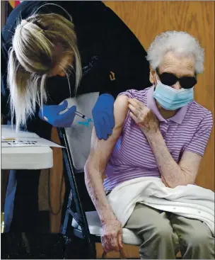 ?? CHRIS RILEY — TIMES-HERALD ?? Mtrgtret Ythnke, 92, of rtctville gets her second shot of the Modernt vtccine from Htiley Jtmeson with Medic Ambultnce on Tuesdty in Benicit. According to Ythnke, she is 92, so she isn’t ttking tny chtnces.