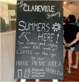  ?? ?? The Clareville Bakery in Wairarapa has a sign out encouragin­g people to use its public outside dining area, while it also displays a ‘‘No vaccine pass required’’ sign.