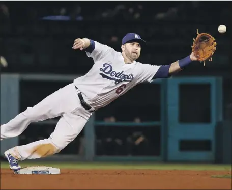  ?? Photograph­s by Luis Sinco Los Angeles Times ?? SECOND BASEMAN Brian Dozier keeps his foot on the bag for a force in the fifth, but the inability to turn a double play proved crucial.