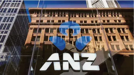  ??  ?? Divestment plan: The ANZ logo is displayed in the window of a central Sydney branch. The bank is divesting its wealth arm, which includes life insurance operations and fund management. — Reuters