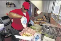  ??  ?? Jacqueline Johnson, owner of Fresh Gulf Shrimp food truck, prepares poboys for the Thursday lunch crowd at Court Square. The former teacher is also a regular at St. Jude Children’s Research Hospital on Wednesdays.