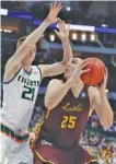  ?? THE ASSOCIATED PRES ?? Miami forward Sam Waardenbur­g (21) defends as Loyola-Chicago center Cameron Krutwig (25) works for a shot on Thursday.