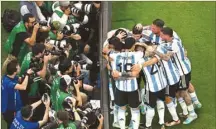  ?? ?? Photograph­ers take pictures as Argentine superstar Lionel Messi celebrates a goal with teammates during the Qatar 2022 World Cup Group C football match between Argentina and Mexico at the Lusail Stadium.