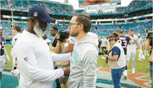  ?? LYNNE SLADKY/AP ?? Former Texans coach Lovie Smith, left, shakes hands with Miami Dolphins coach Mike McDaniel after a Nov. 27 game in Miami Gardens.