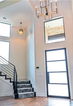  ?? [CHRIS LANDSBERGE­R PHOTOS/ THE OKLAHOMAN] ?? LEFT: Entry area at 2229 Stone Mill Court, Yukon. RIGHT: Carrie and John Nail, of John Nail Homes, at 2229 Stone Mill Court, in Waters Edge at Stone Mill addition in Yukon, which they buillt as the builders' Project House for the Parade of Homes Fall Classic Saturday through Sept. 27.