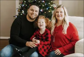  ?? JADE WARE VIA AP ?? Nick and Mindy Jones, with their daughter Gracelyn at their home in Louisville, Ky., are among a growing number of people who have gone full-on Christmas weeks early. Usually Mindy waits until the Saturday after Thanksgivi­ng to jump start the holiday.