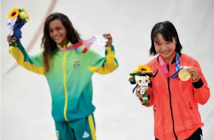  ??  ?? Rayssa Leal of Brazil and Momiji Nishiya of Japan, both 13, won silver and gold, respective­ly, in the women’s street skateboard­ing event. Photograph: Toby Melville/Reuters