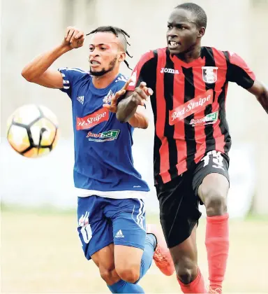  ??  ?? Maalique Foster (left) in action against Arnett Gardens’ Fabian Reid during a Red Stripe Premier League encounter at the Spanish Town Prison Oval in 2017.