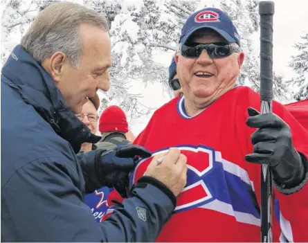  ?? FILE ?? NHL legend Guy Lafleur was a popular man in Windsor when he attended the 2016 Long Pond Heritage Classic. He made several autograph signings throughout the town – including at Long Pond. Pictured having his shirt signed is David Allen.