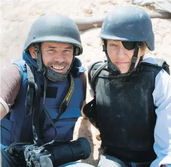  ??  ?? Photograph­er Paul Conroy, left, with war correspond­ent Marie Colvin in Libya. A new film recounts in searing detail the final days of Colvin, who was killed in Syria in 2012.