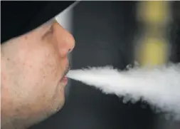  ?? Picture: AFP ?? QUICK DRAG. Jeremy Wong blows vapour from an e-cigarette at The Vaping Buddha in San Francisco, California.