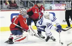  ?? NICK WASS / THE ASSOCIATED PRESS ?? Toronto’s William Nylander reaches for the puck in front of Washington goalie Philipp Grubauer.