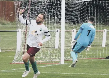  ??  ?? Former Posh player Lee Clarke after scoring for Blackstone­s at Raunds.