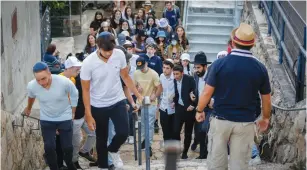  ?? (David Cohen/Flash90) ?? TOURISTS FROM the US last week visit the scene of the Mount Meron disaster where 45 pilgrims were killed in a stampede on Lag Ba’omer in April.