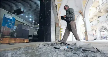  ?? Photo: REUTERS ?? Blast aftermath: A man walks past debris from a damaged shop after a blast hit central Cairo.