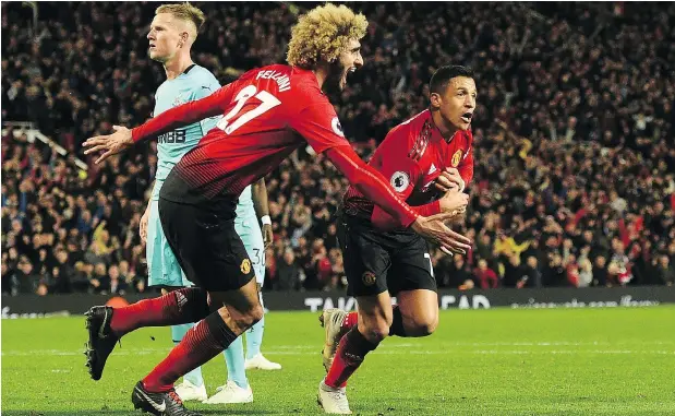  ?? — GETTY IMAGES ?? Manchester United’s Alexis Sanchez, right, celebrates after scoring the winner in a stunning 3-2 comeback victory over Newcastle.