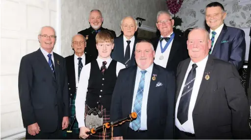  ??  ?? Hitting the right notes Club members with piper Niall Beattie (front row, third left) at the special 135th anniversar­y dinner