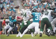  ?? Phelan M. Ebenhack / Associated Press ?? New York Jets quarterbac­k Sam Darnold sets up to throw a pass between Jacksonvil­le Jaguars defensive end Yannick Ngakoue (91) and cornerback Breon Borders.