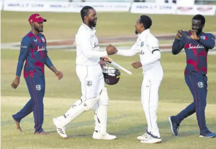  ?? (Photo: AFP) ?? West Indies’ Kyle Mayers (second left) celebrates with a teammate after West Indies won the first cricket Test match between Bangladesh and West Indies at the Zohur Ahmed Chowdhury Stadium in Chittagong on Sunday.