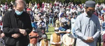  ??  ?? Worshipper­s participat­e in an Eid al-Fitr prayer at the Islamic Center of Wheaton in Wheaton, Illinois. The prayer, typically held inside of the mosque, was held outside as the risk of Covid-19 continues to be a concern.