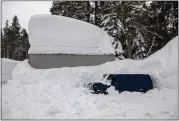  ?? ?? A van is dwarfed by deep snow in the parking lot of UC Berkeley's Central Sierra Snow Lab in Soda Springs.