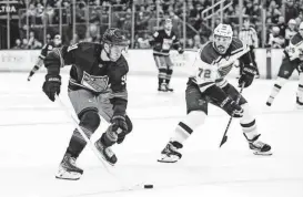  ?? DANNY WILD/USA TODAY SPORTS ?? Rangers center Alex Wennberg (91) skates in with the puck against Blues defenseman Justin Faulk (72), who was called for hooking during the second period Saturday at Madison Square Garden.