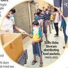  ?? PHOTO: HTCS ?? Team Usha Shriram distributi­ng food packets