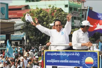  ?? Heng Sinith / Associated Press ?? Cambodia National Rescue Party leader Kem Sokha greets supporters at a June rally in Phnom Penh. The opposition leader has been imprisoned since September, charged with treason.