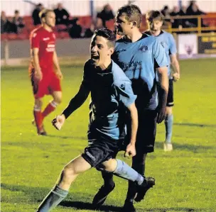  ?? Paul Watson ?? Craig Cairns celebrates ( front) after teammate Paul McManus ( behind) netted a late penalty to win the points for Runcorn Town in their clash with Hanley Town at Pavilions last Wednesday night.
