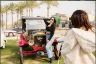  ?? ?? Classic cars enthusiast Carine Sherif poses in front of a 1924 Ford T owned by Egyptian collector Mohamed Wahdan during a classic car show in Cairo, Egypt, Saturday, March 19, 2022. (AP)