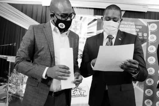  ?? CONTRIBUTE­D ?? Minister of Agricultur­e and Fisheries Floyd Green (right) peruses an applicatio­n form with Jordon Tait, assistant general manager of GK Insurance, at the launch of GK Weather Protect, a crop insurance policy developed specifical­ly for farmers and fishers. The launch was held at the ministry’s Hope Gardens offices on Tuesday.